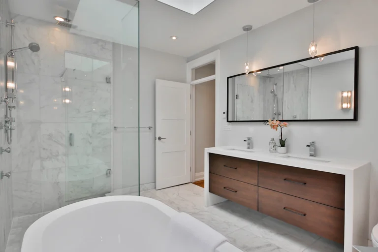 Bathroom with a freestanding tub beside a walk-in shower