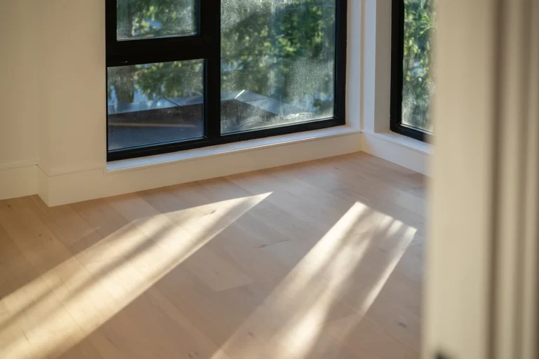 Sunlight across light wooden floorboards